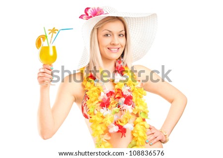 Portrait of a female dressed in a hawaiian costume holding an orange cocktail isolated on white