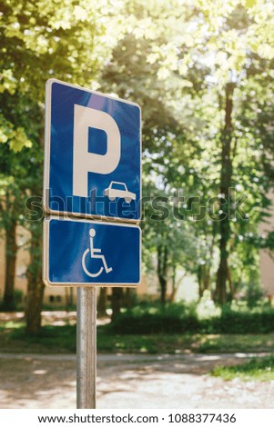 Disabled person parking spot sign, reserved lot space for handicapped person, selective focus