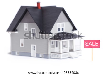 Household architectural model with sale sign, isolated on white