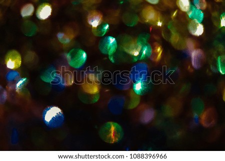 Abstract festive glitter vintage lights background with lights defocused.