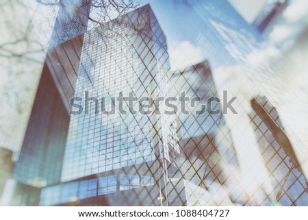 Urban abstract background of glass skyscrapers with reflected sky in the windows, texture, double exposure photo