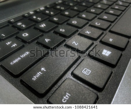 In computing, a computer keyboard is a typewriter-style device which uses an arrangement of buttons or keys to act as a mechanical lever or electronic switch. Royalty-Free Stock Photo #1088421641