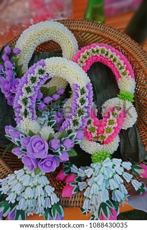 A garland is a circular decoration made from flowers such as  jasmine, rose, crown flower and leaves. It is worn for ornament or as an honor or hung on something as a decoration.