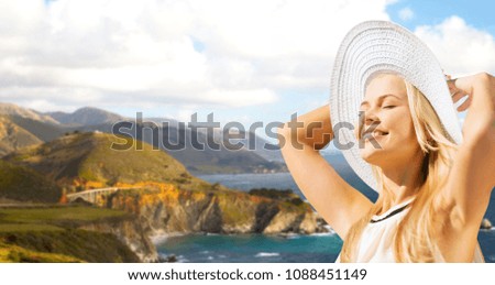 travel, tourism and summer vacation concept - beautiful woman in hat enjoying sun over bixby creek bridge on big sur coast of california background