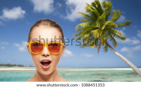 travel, tourism, summer holidays, vacation and people concept - amazed young woman or teenage girl in sunglasses over exotic tropical beach background