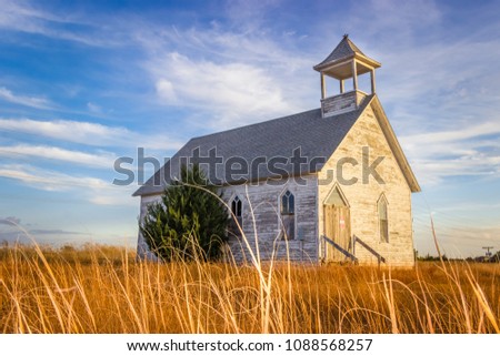 Abandoned Wooden Church Building in the Midwest Prairie under Blue Summer Sky Royalty-Free Stock Photo #1088568257