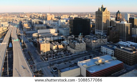  Aerial view of american city at dawn. High-rise  buildings, freeway, bay.  Sunny morning. Milwaukee, Wisconsin, USA
