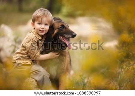 a little child with a big dog are best friends Royalty-Free Stock Photo #1088590997