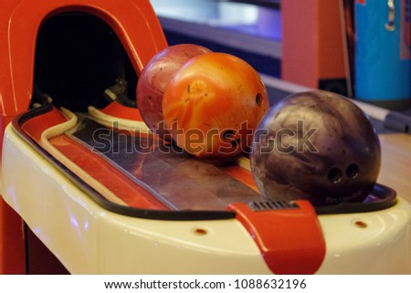 Colorful bowling balls on the bowling track. Game and Fun