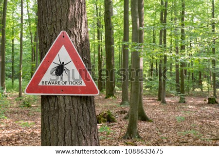 tick insect warning sign in forest Royalty-Free Stock Photo #1088633675