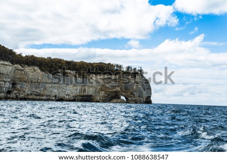 rock formations along the Upper Peninsula of Michigan seen from lake Superior in the fall with rough water