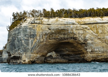 rock formations along the Upper Peninsula of Michigan seen from lake Superior in the fall with rough water