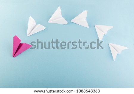 One Unique Pink Paper Plane among Many Ones. Different Paper Airplanes as Individuality and Leadership Concept
