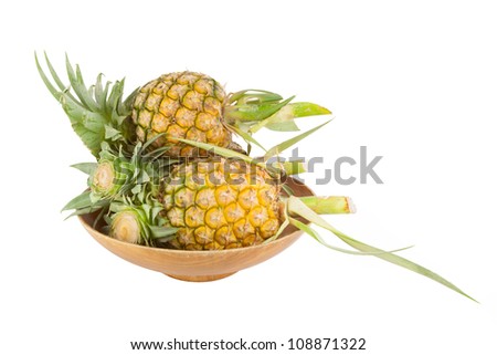 Pineapples on wooden plate