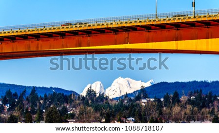 Mission Bridge over the Fraser River on Highway 11 between the towns of Abbotsford and Mission in British Columbia, Canada with Mount Robie Reid over the town of Mission Royalty-Free Stock Photo #1088718107