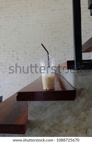 Cup of coffee on wood with colorful background.