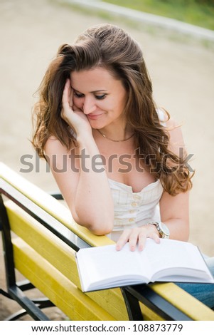 beautiful woman read a book in park
