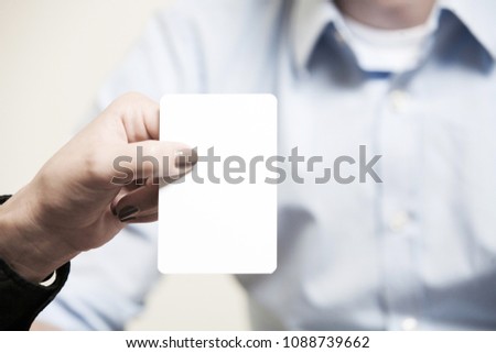 blank white card, a woman holds it with her hand