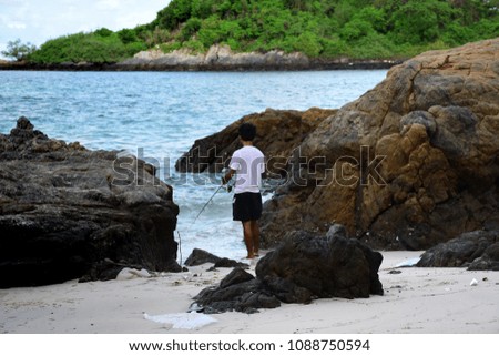 Photography of man fishing on the beach.