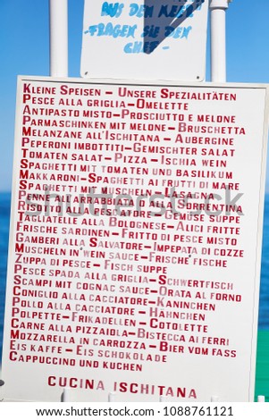 Italian restaurant menu translated for German tourists, saying 'seafood - ask the chef' and 'Ischia cuisine'