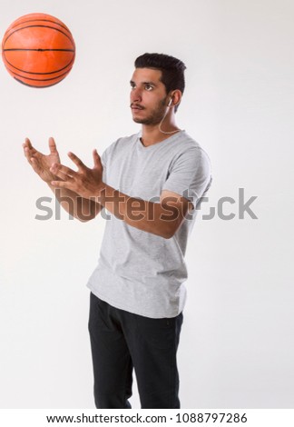 handsome man standing with basket ball
