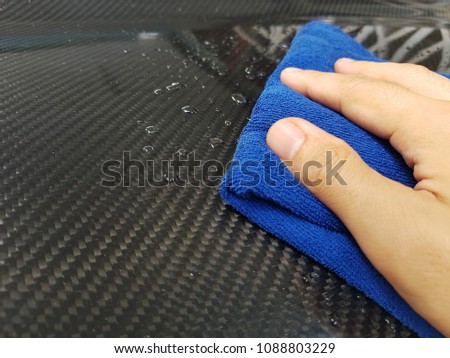 Right hand cleaning car with blue cloth