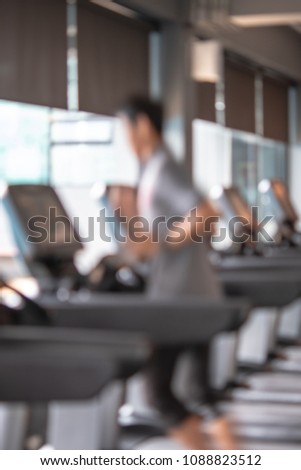 Row of treadmills in modern fitness center. Blurred picture of Running people. Gym equipment.