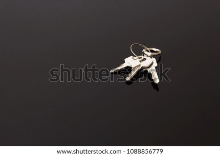 Keys on a black reflecting surface background closeup
