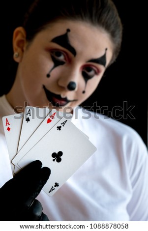 female joker showing a poker of ACEs