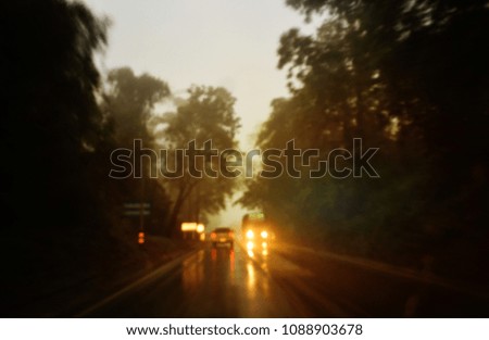 blurred background. blurred picture. people driving a car rainy on the way. transportation in rain fall.