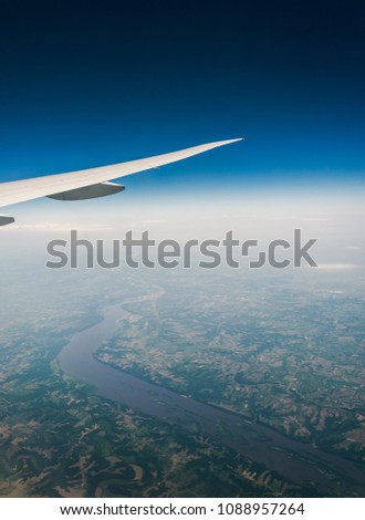 Airplane flying above the beautiful landscapes