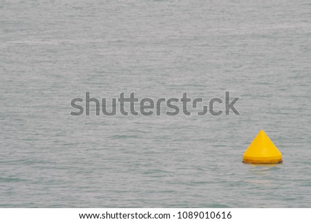 Yellow buoy to ensure safety mooring of sailors. Marine background