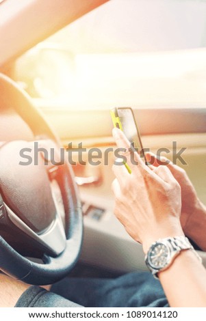 people hold smartphone in a car.