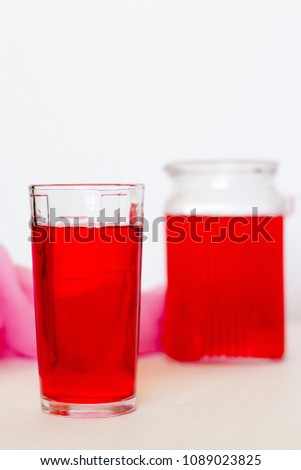Fruit and berry red juice in glasses on a white background. 