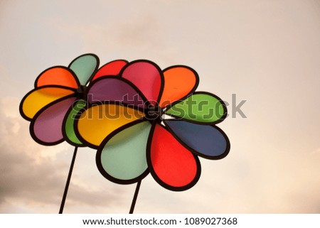 Colorful pinwheels with sky background.