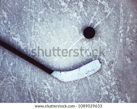 hockey puck and stick on the ice texture background