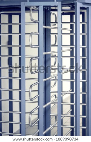 Turnstile grille close-up. Passage to the official territory only for employees Concept of security, lock, gates, business, loneliness, prison, dangerous.
