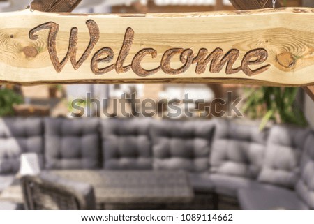 Relaxing lounge corner in modern design and welcome sign