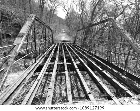 The truss and girders on an abandoned bridge.