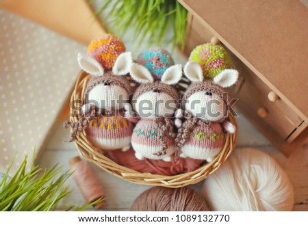 Handmade knitted toys. 3 knitted bunnies in colorful sweaters and hats with big pompoms ?? small basket. Easter gift card