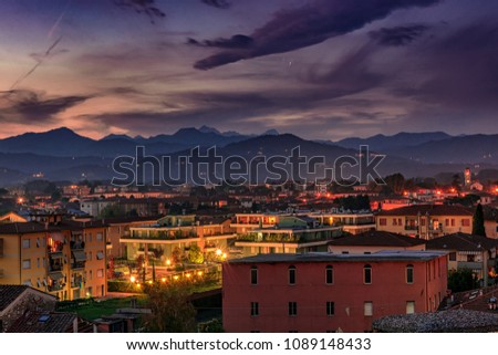 City of Lucca in Italy in a blue hour time with mountains in background