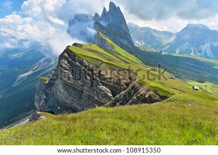 Odle mountains chain separating the  Funes valley from the Gardena valley, taken from the Seceda refuge, Italian alps Royalty-Free Stock Photo #108915350