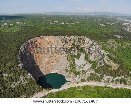 Red Lake (Croatian: Crveno jezero) is a collapse doline (sinkhole) containing a karst lake close to Imotski, Croatia. It is about 530 metres deep, thus it is the largest collapse doline in Europe. Royalty-Free Stock Photo #1089161489