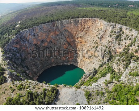 Red Lake (Croatian: Crveno jezero) is a collapse doline (sinkhole) containing a karst lake close to Imotski, Croatia. It is about 530 metres deep, thus it is the largest collapse doline in Europe. Royalty-Free Stock Photo #1089161492