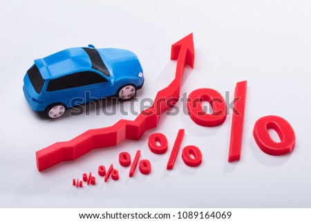 Elevated View Of Growing Red Percentage Symbol And Arrow Sign Near Blue Car