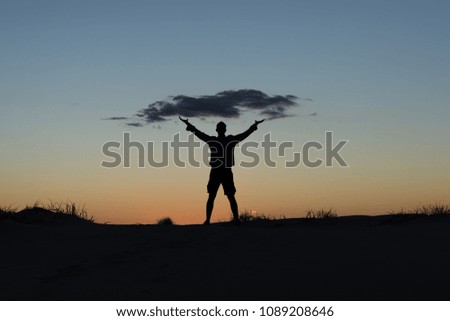 Man silhouette holds the cloud in sunset. Concept image on cloud computing and eco theme