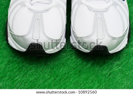 Toe of sneakers on grass – ready for a workout