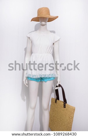 mannequin in female dress with blue shorts jeans  with hat, bag, –white background

