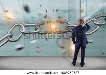View of a Businessman in front of a wall with Weak link of a Broken chain exploding - 3d render