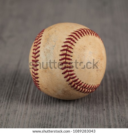 worn baseball on the wooden Table, sport.